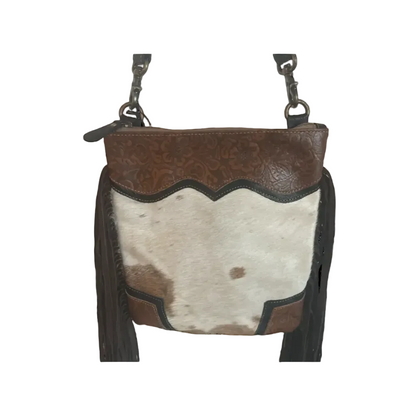 Brown leather and cowhide leather handbag with fringe on a white background