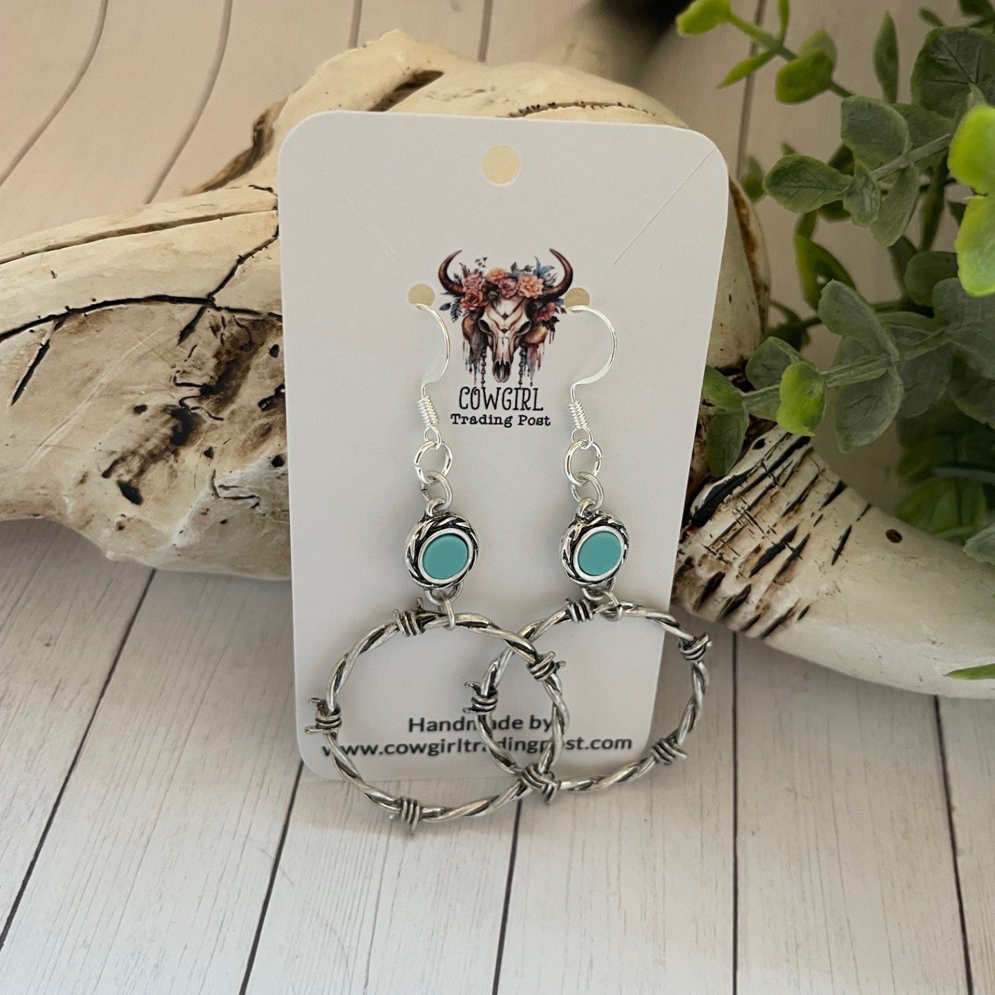 Cowgirl Jewelry Co. earrings on a white card with natural background