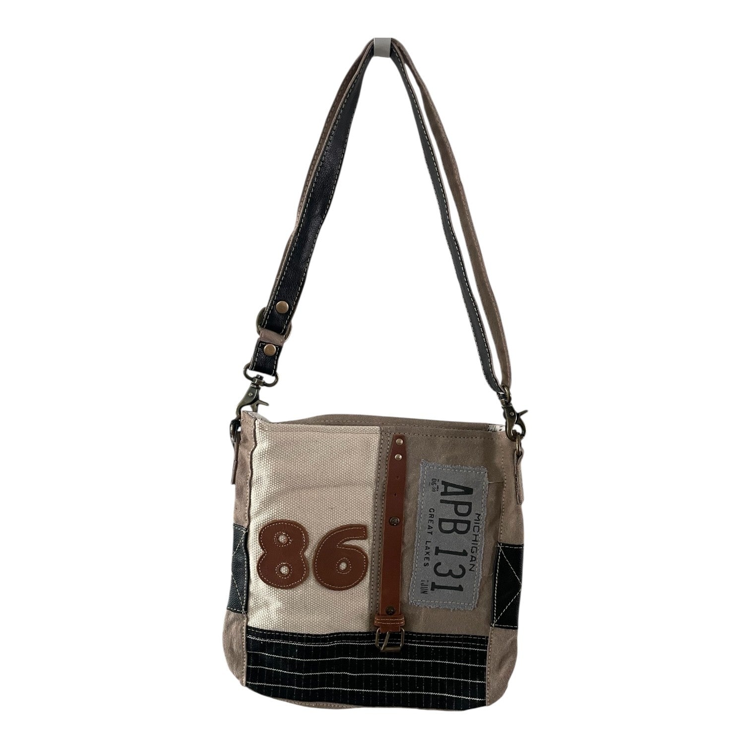 Patchwork-style shoulder bag with visible branding on a white background