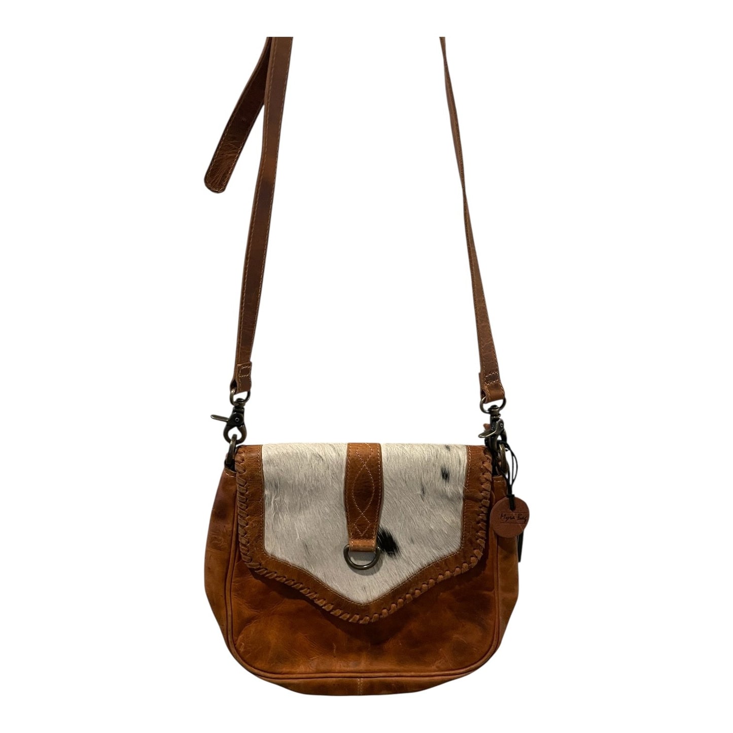 Brown leather crossbody bag with white cowhide section on a white background