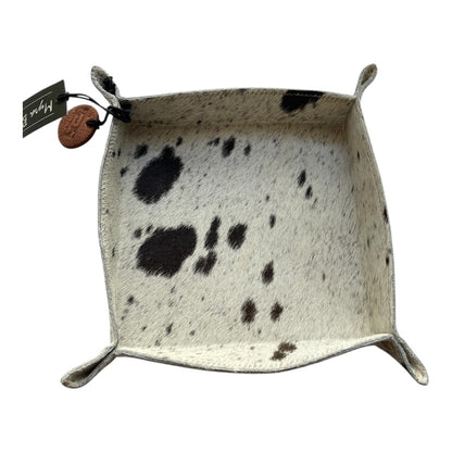 Square leather tray with cowhide pattern on a white background