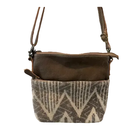 Brown leather and patterned fabric crossbody bag on a white background