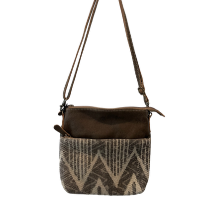 Brown crossbody bag with patterned front pocket on a white background