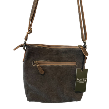 Brown leather handbag with a tag on a white background