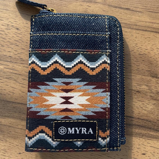 Denim wallet with geometric pattern and 'MYRA' brand logo on a wooden surface