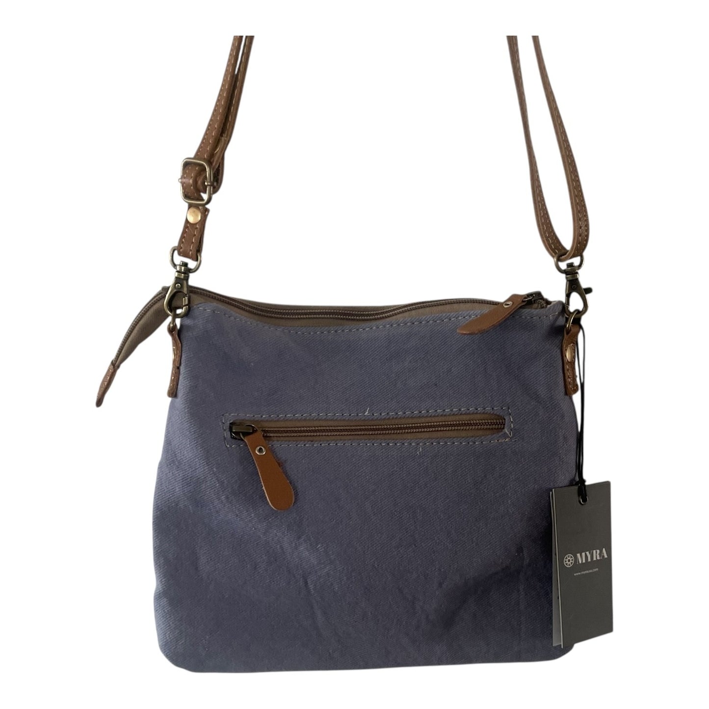 A slate blue canvas shoulder bag with brown leather trim, a front zippered pocket, and a hanging brand tag that reads 'MIRA'.