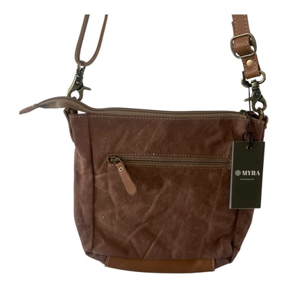 A brown textured canvas crossbody bag with a front zippered pocket, brown leather trim, and a black MYRA brand hangtag, shown on a plain white background.