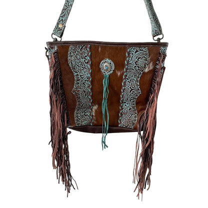 Brown leather handbag with fringe and decorative patterns on a white background