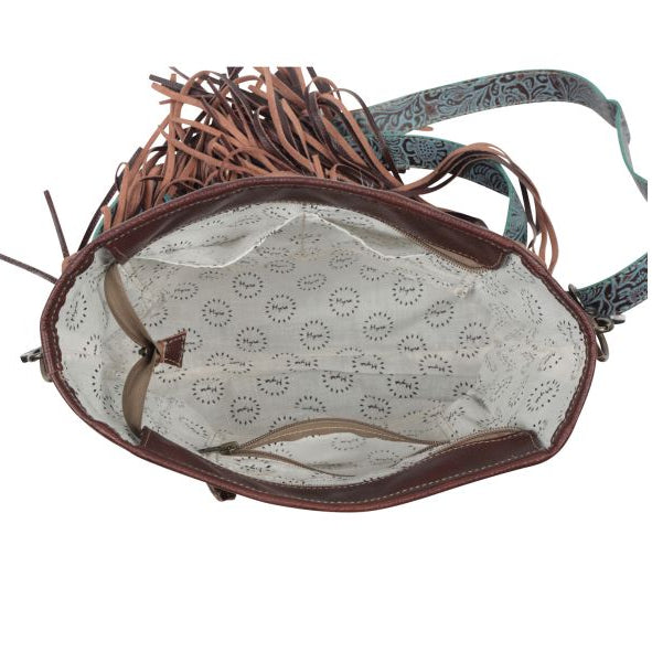 Brown leather handbag with decorative tassels on a white background