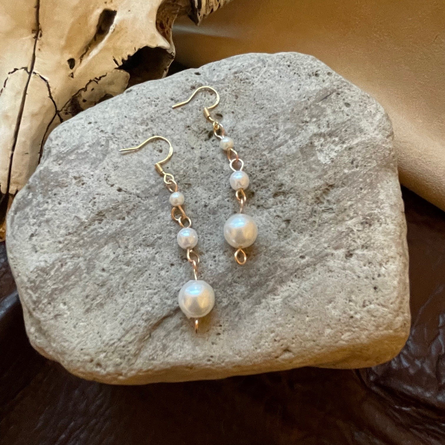 minimalistic and simple, yet so pretty! Pearl beads hanging from gold ear wires, in graduated bead sizes. Perfect for so many looks. Earrings measure approximately 2.25 inches in total length,.