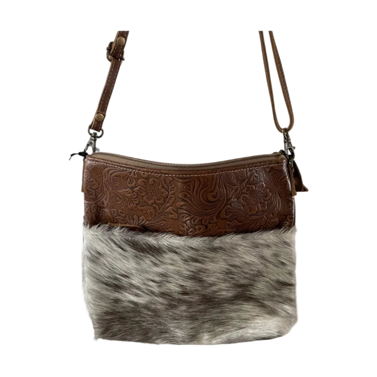 Brown leather and cowhide crossbody bag on a white background