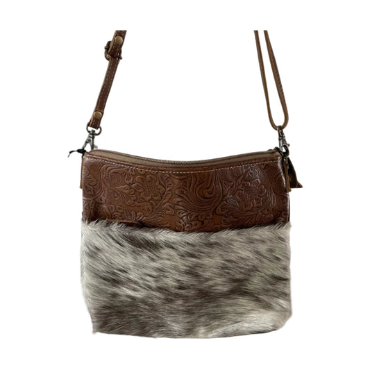 Brown leather and cowhide crossbody bag on a white background