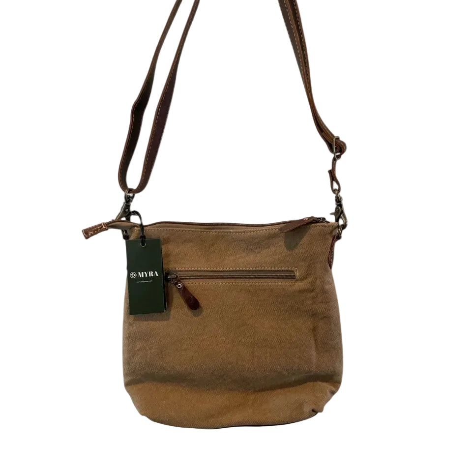 Brown leather handbag with a visible brand tag on a white background