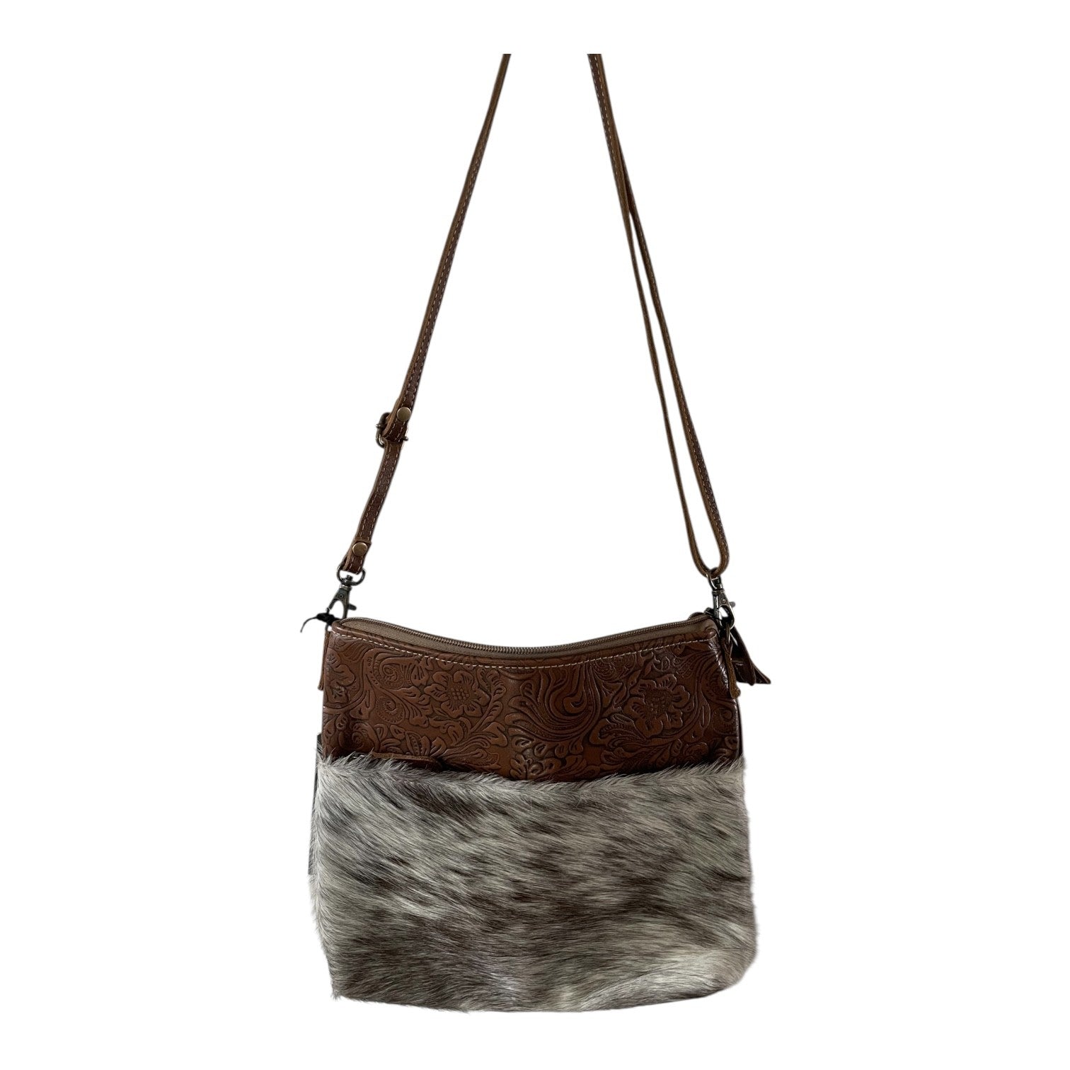 Brown leather and cowhide crossbody bag on a white background