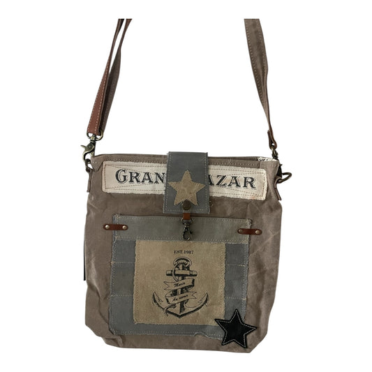 Brown patchwork bag with star designs and 'Gran Bazar' text on a white background