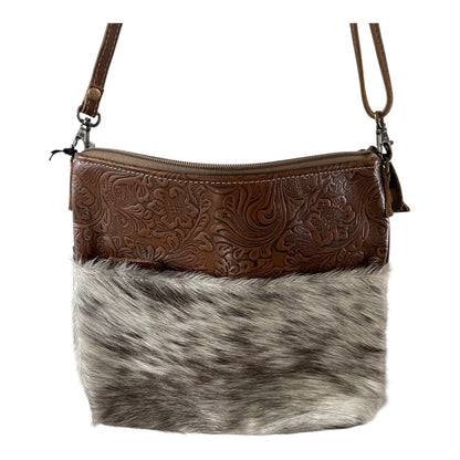 Brown leather and fur handbag on a white background