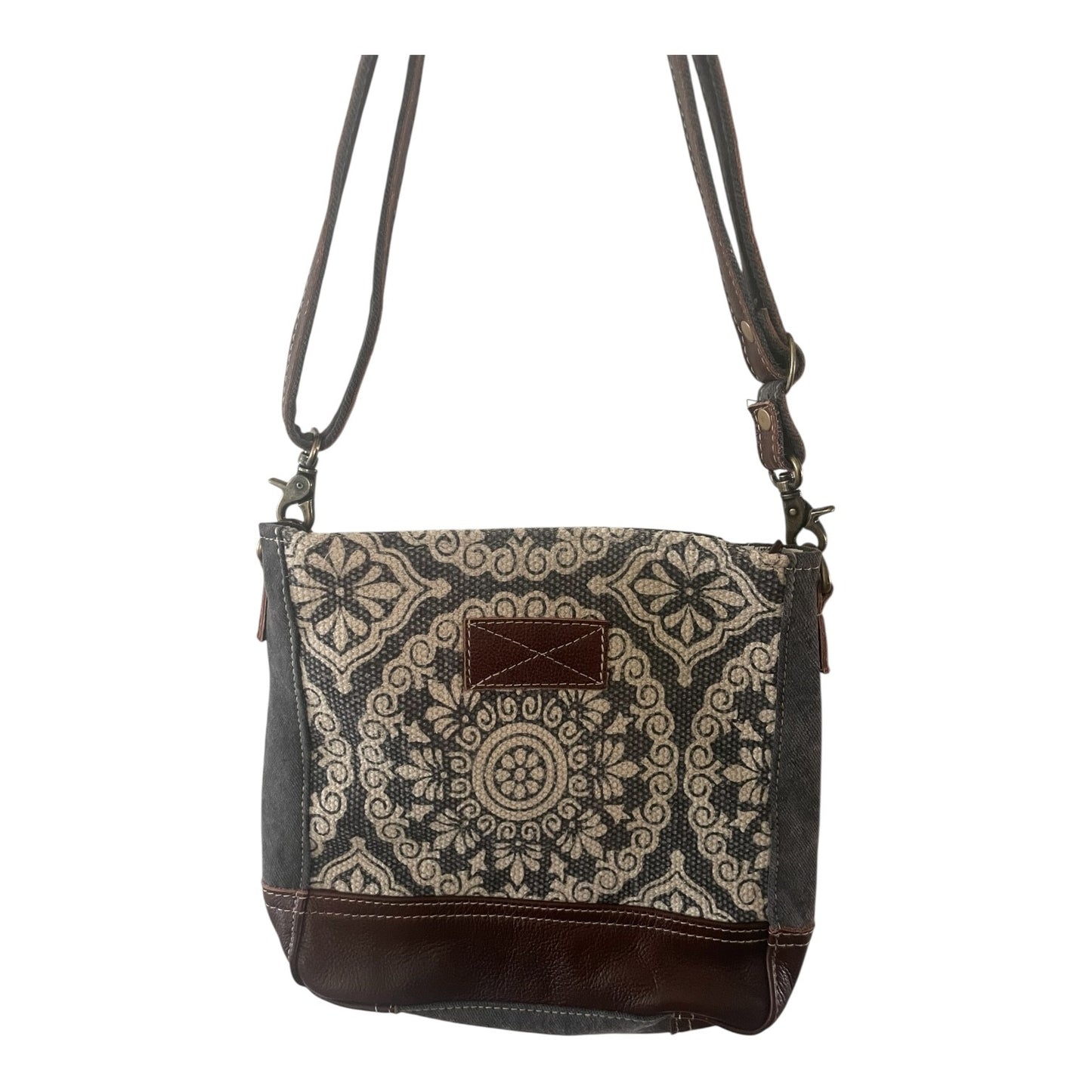 Patterned crossbody bag with brown accents on a white background