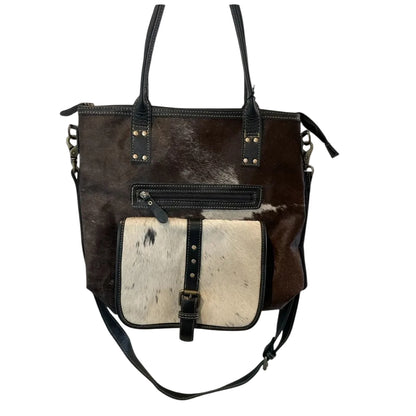 Brown and black leather handbag with a contrasting white section on a white background