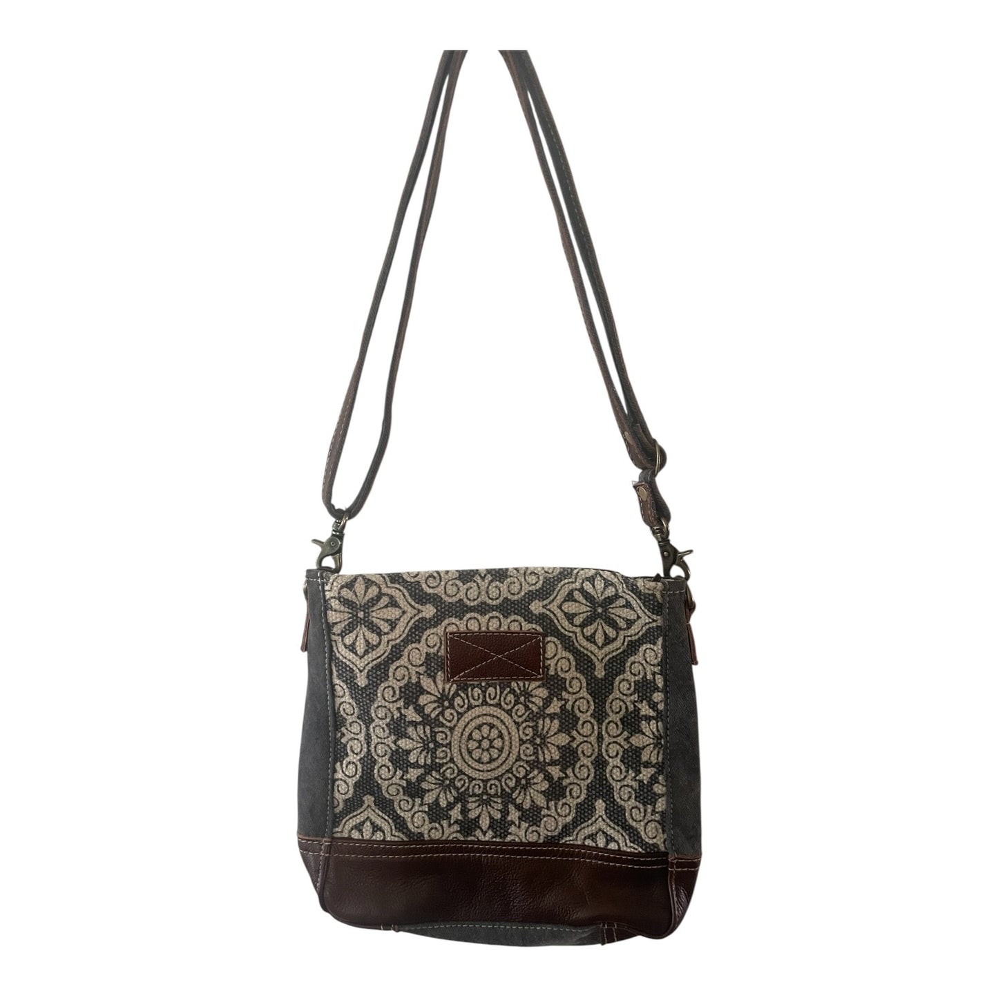 Patterned shoulder bag with brown accents on a white background