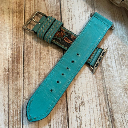 Teal watch strap on a wooden surface