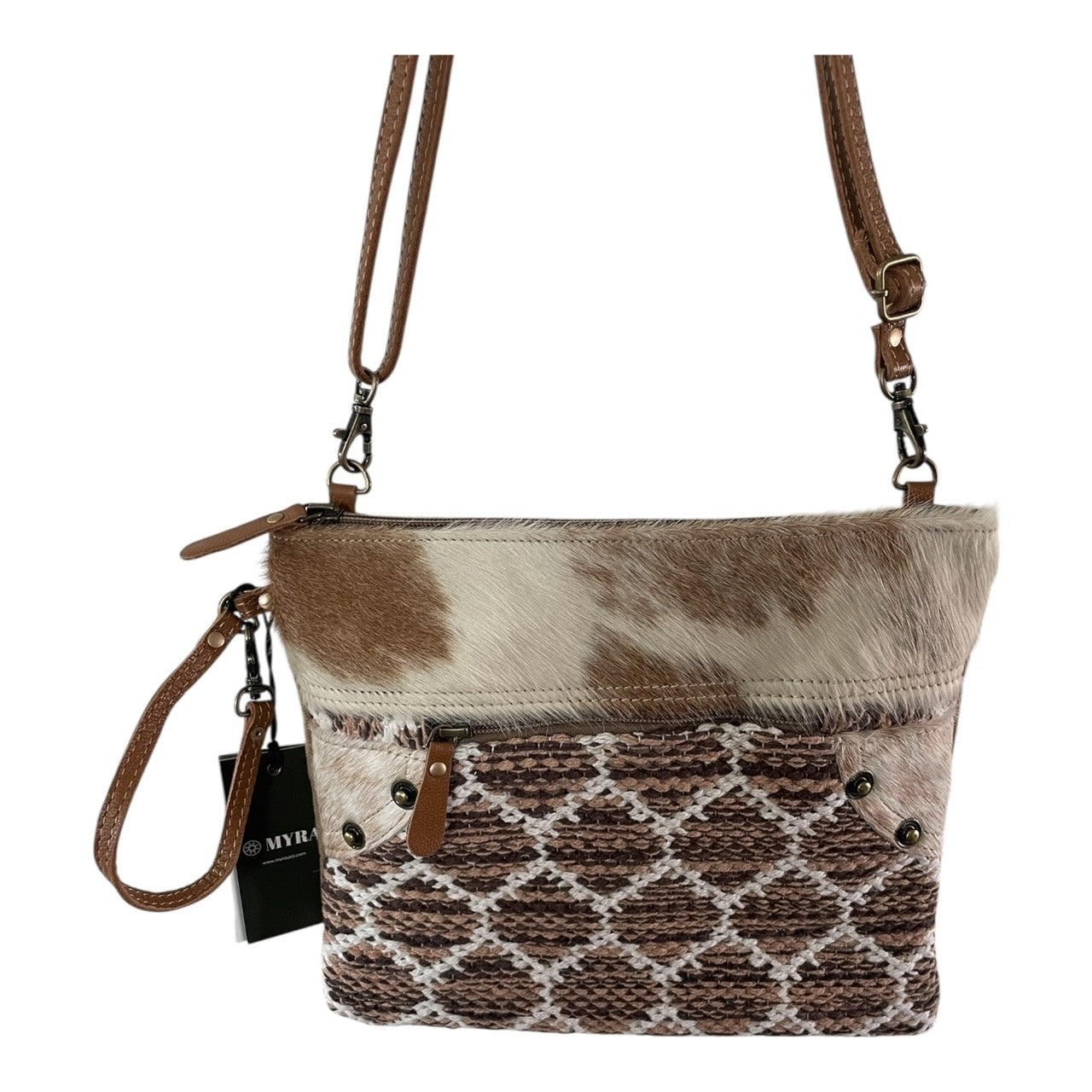 Brown and white cowhide and geometric pattern purse with thin shoulder strap and wristlet