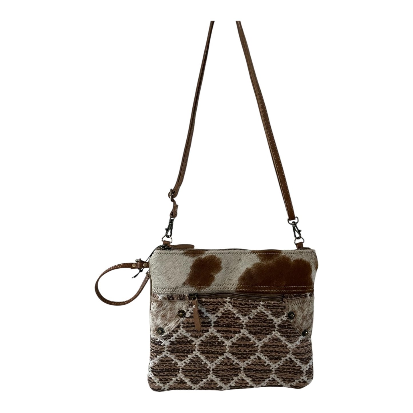 Crossbody bag with cowhide pattern on a white background