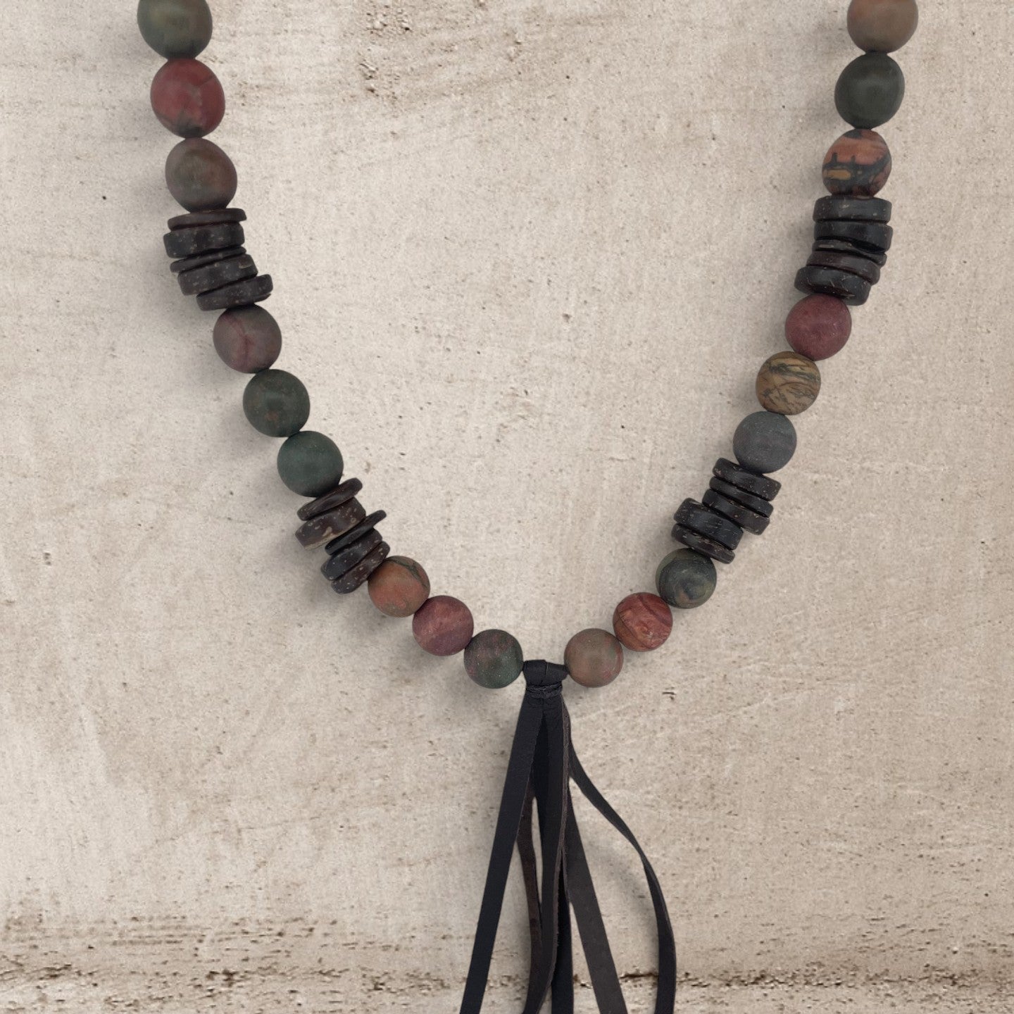 Jasper stone and wood round beads necklace with a leather tassel on a long necklace