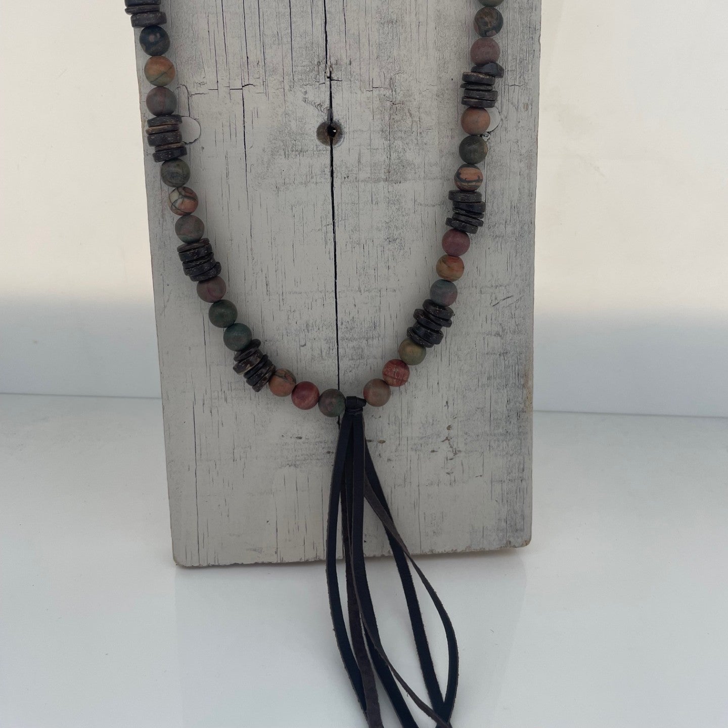 Jasper stone and wood round beads necklace with a leather tassel on a long necklace