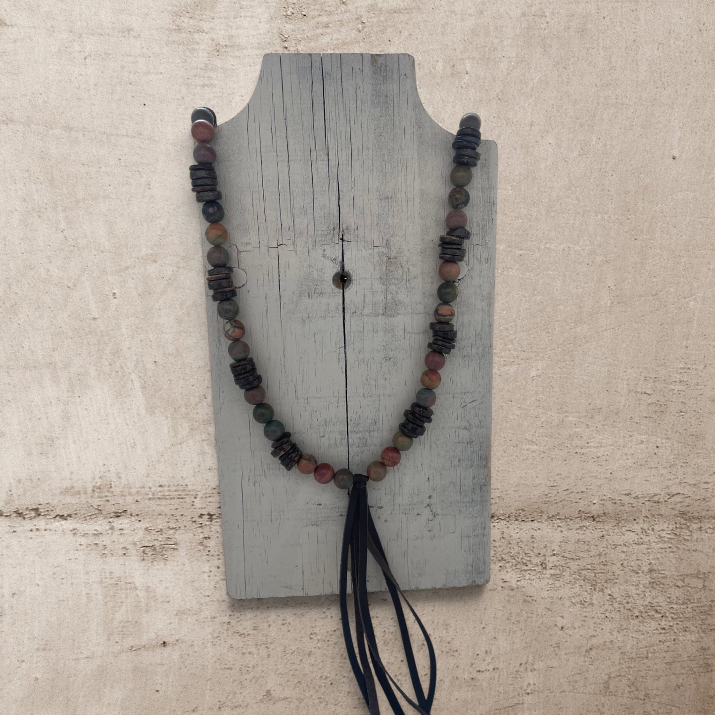 jasper round stone beads on a long necklace with a leather brown tassel