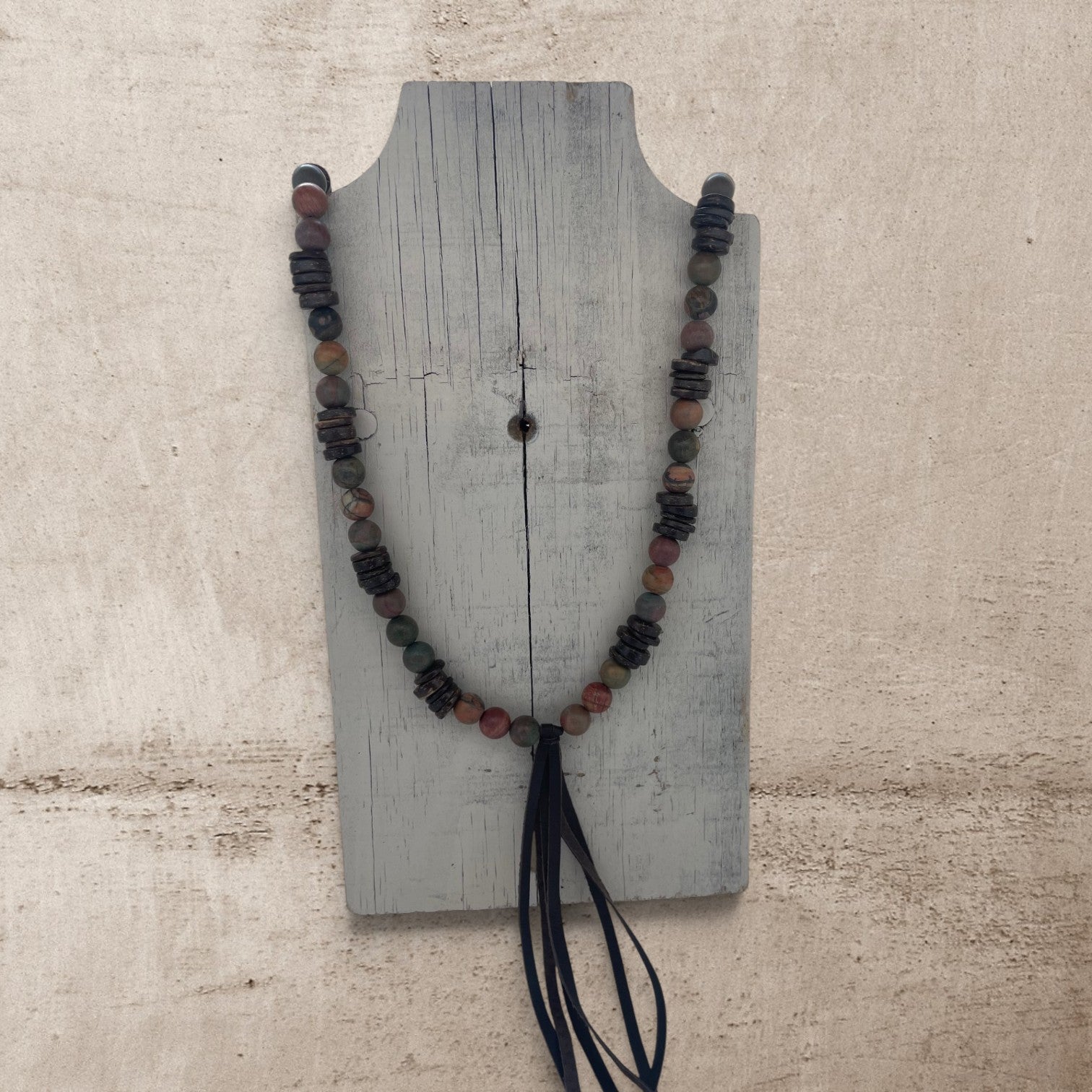 jasper round stone beads on a long necklace with a leather brown tassel