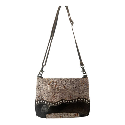 Patterned handbag with a strap on a white background