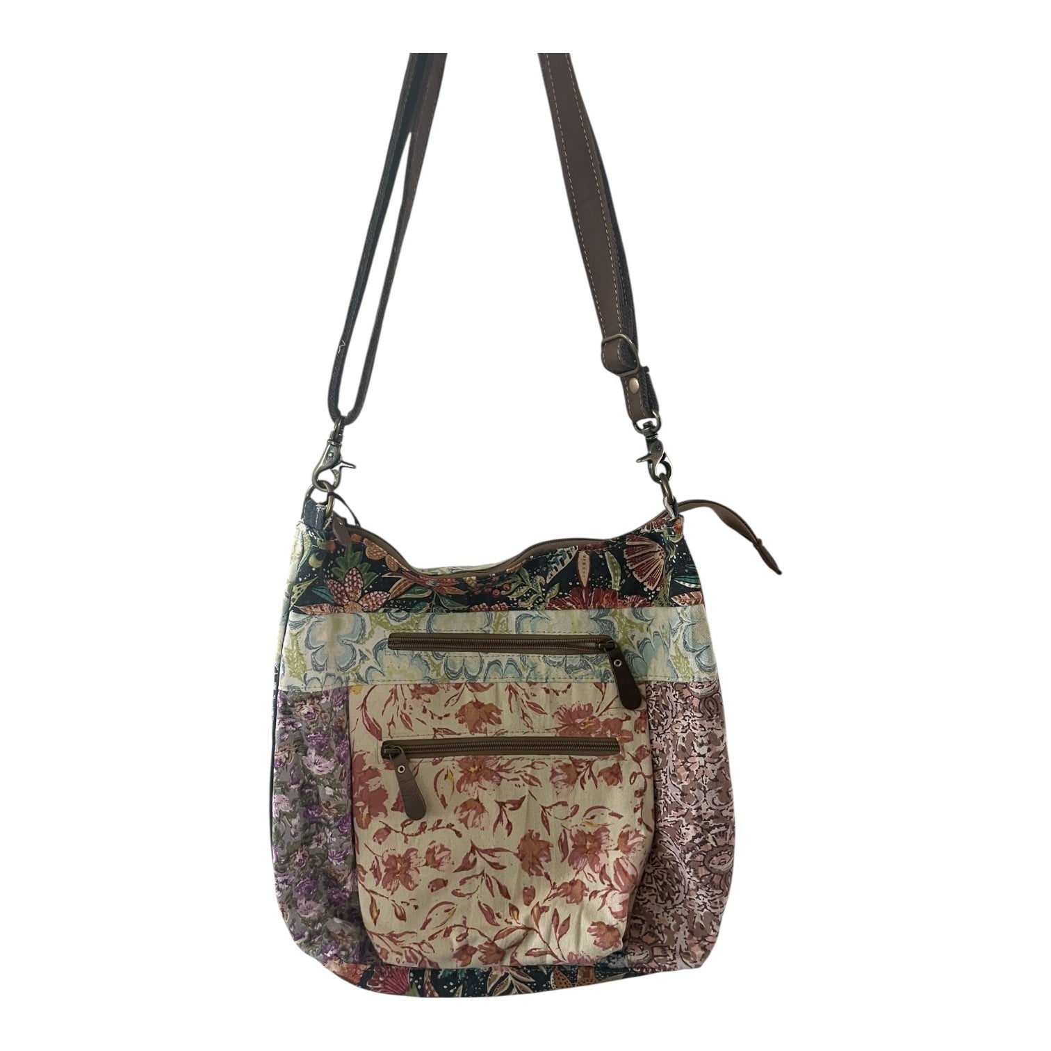 Floral patterned handbag with a strap on a white background