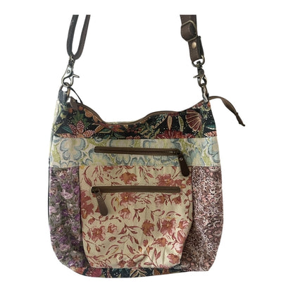 Multicolored floral-patterned handbag with a strap on a white background