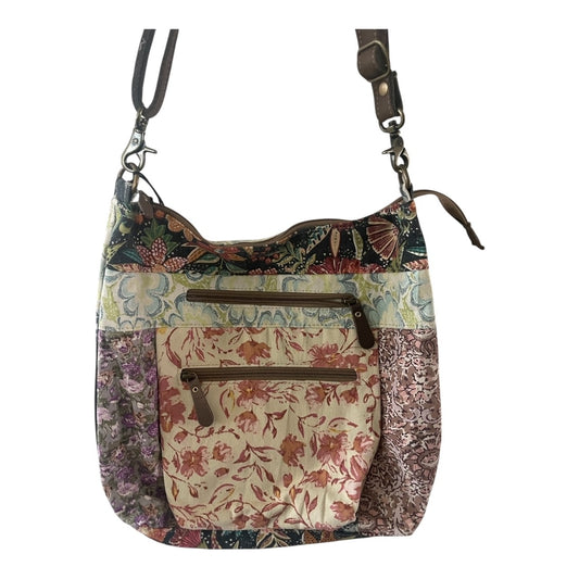 Multicolored floral-patterned handbag with a strap on a white background