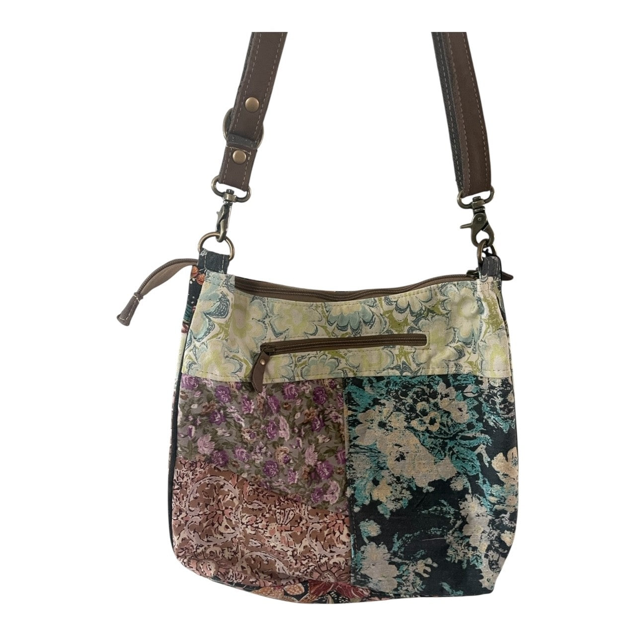 Multicolored patchwork bag with brown straps on a white background