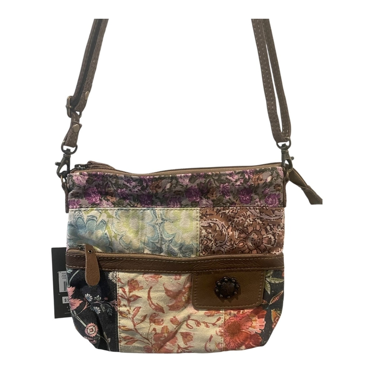 Multicolored patchwork crossbody bag with floral patterns on a white background