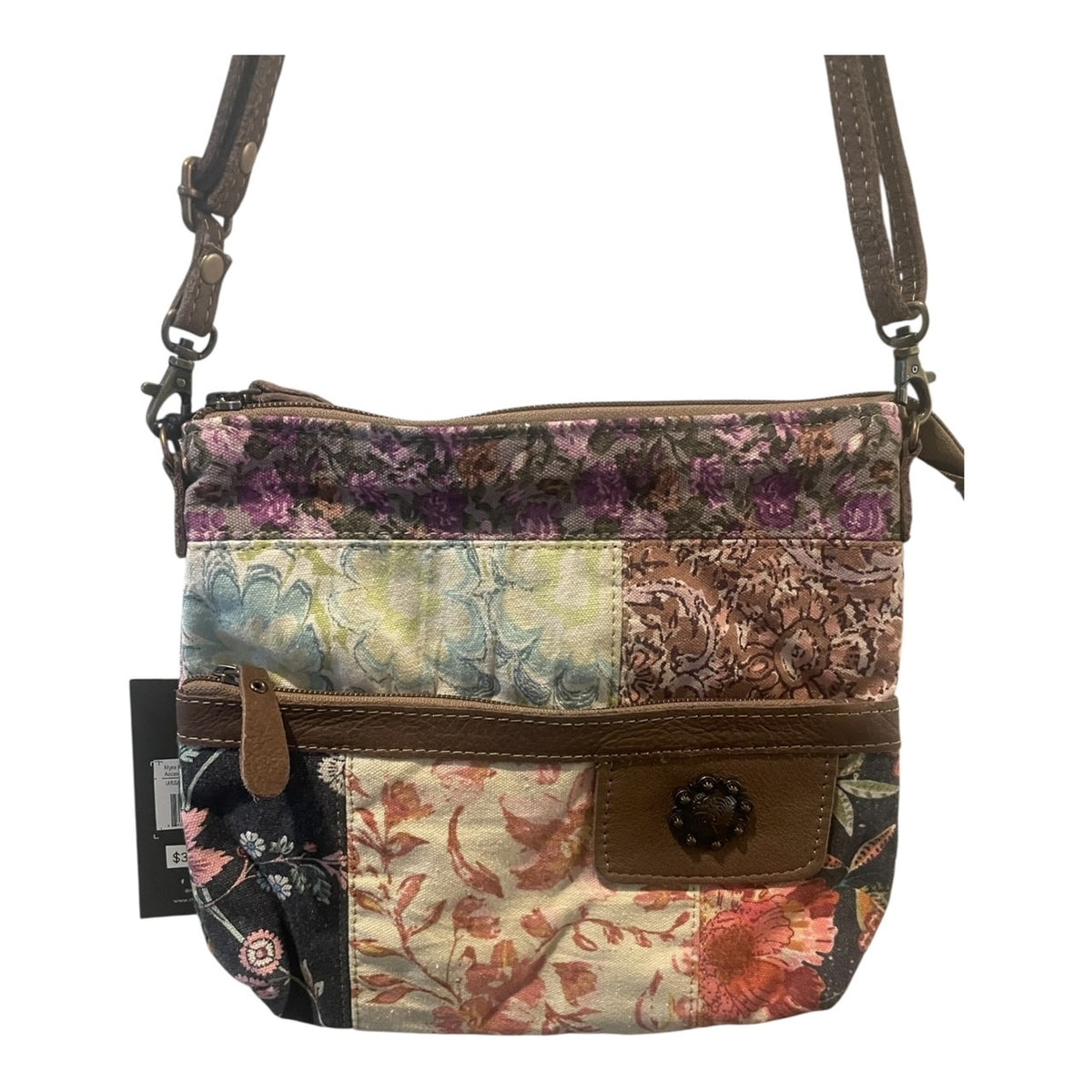 Multicolored floral-patterned crossbody bag with a brown strap on a white background