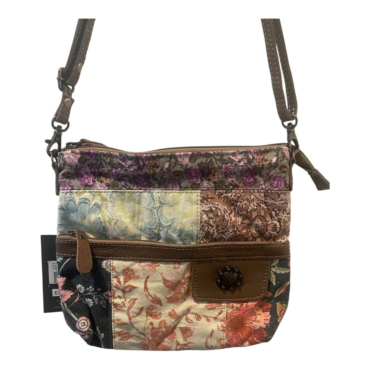 Multicolored patchwork handbag with floral patterns on a white background