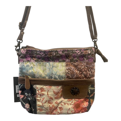 Multicolored patchwork handbag with floral patterns on a white background