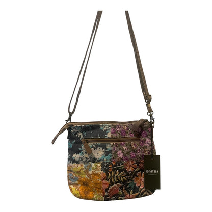 Multicolored floral-patterned handbag with a strap on a white background