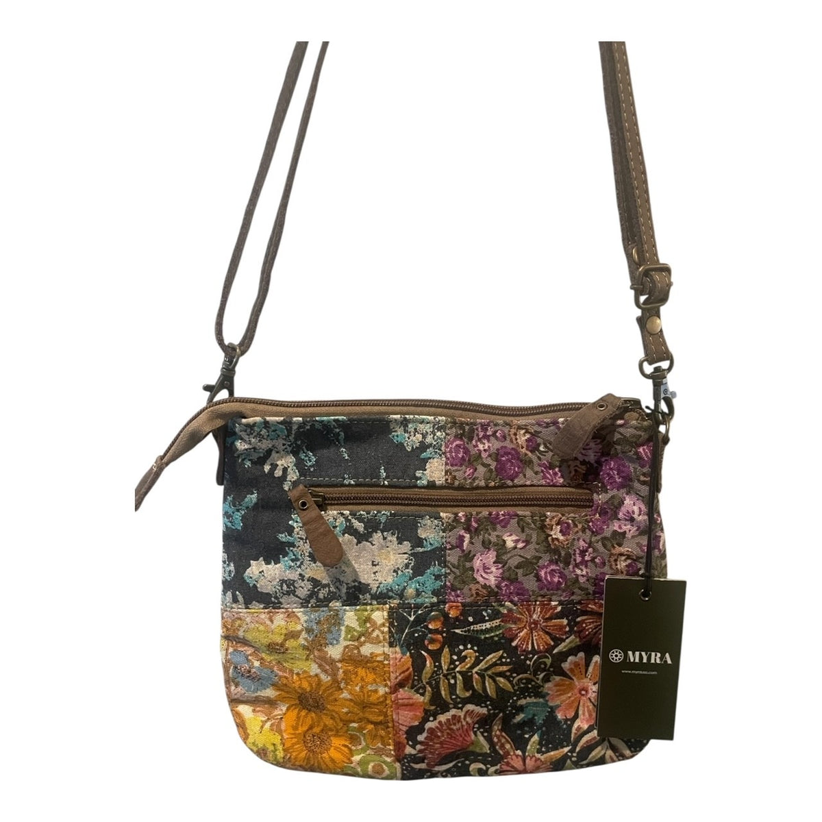Floral patterned handbag with a visible brand tag on a white background
