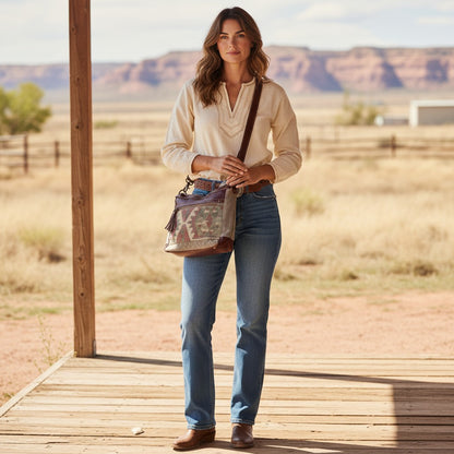 Woman holding a patterned handbag in a desert landscape