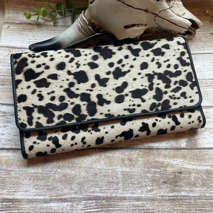 Leopard print wallet on a wooden surface with a rustic background