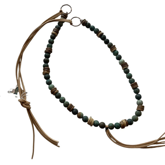 Necklace with beaded chain and brown leather cord on a white background