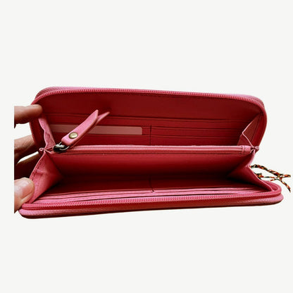 Pink wallet with a zipper on a white background