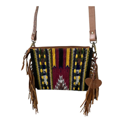 Multicolored patterned handbag with fringe details on a white background