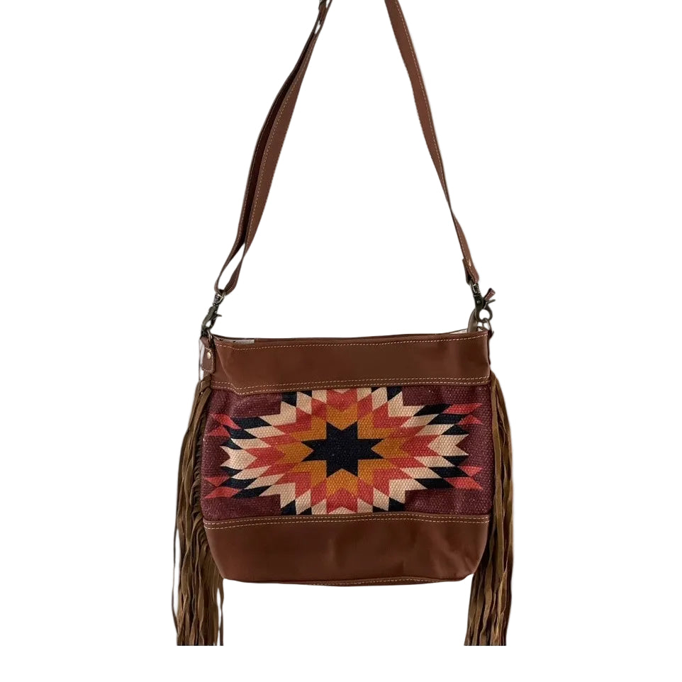 Brown leather handbag with a colorful geometric pattern on a white background