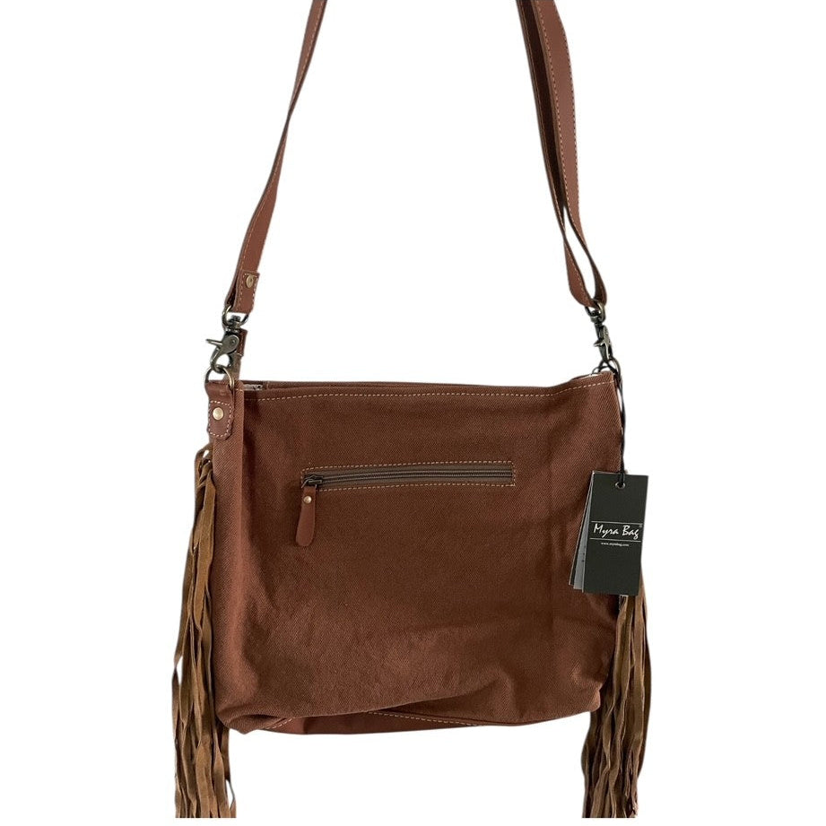 Brown leather handbag with fringes and a visible brand tag on a white background