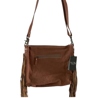 Brown leather handbag with fringes and a visible brand tag on a white background