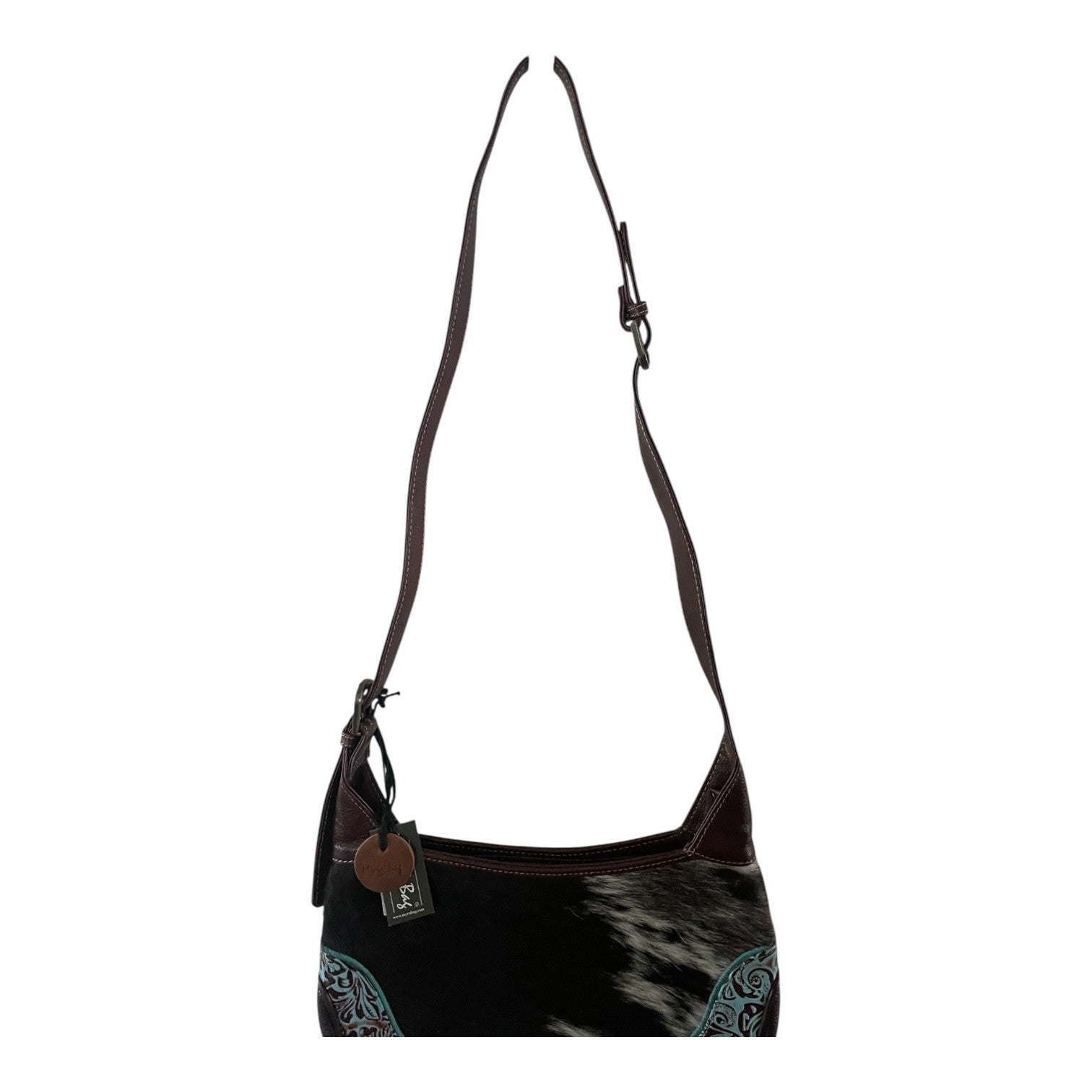 Black and brown handbag with cowhide pattern on a white background